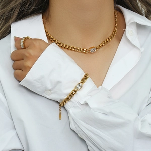 Detailed view of 18K gold plated Cuban chain necklace and bracelet with zircon pendants