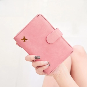 Pink PU leather passport holder with gold airplane icon and RFID protection feature