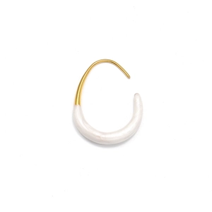 Close-up of minimalist gold U-shaped earrings with pearl white resin dripping detail