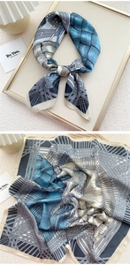 Close-up of blue geometric woven pattern on satin neck scarf for women with elegant drape