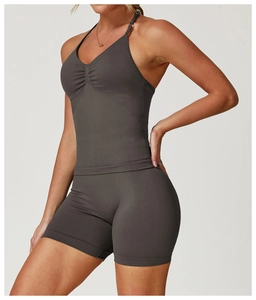 Detail view of seamless dark grey yoga set with gathered front vest and high waist shorts