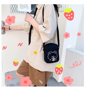 Black canvas crossbody bag featuring a cute cartoon bear embroidery and adjustable strap