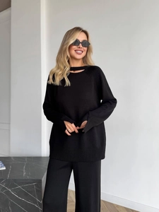 Women's two-piece black knit set with split collar sweater and wide-leg trousers