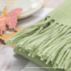 Detail of soft green knit scarf showing the durable secondary twisted tassels texture