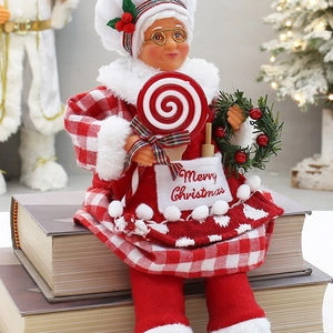Detailed close-up of a festive Christmas grandmother doll sitting on books with gifts