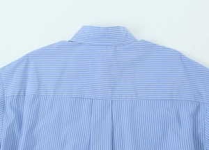 Close-up of a blue and white striped shirt collar showing precise stitching and fabric quality
