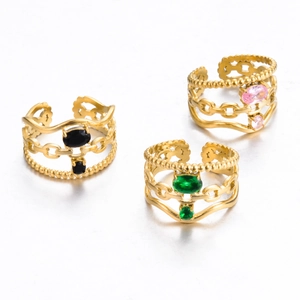 Detail of triple-layer gold rings with colorful zircons in chain and wave patterns