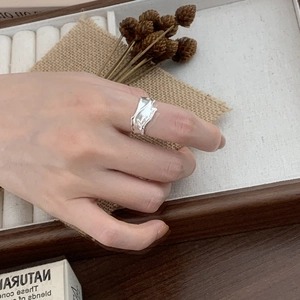 Detail of 925 sterling silver ring with organic crinkle texture on model finger