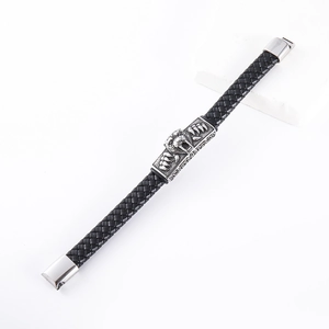 Detailed view of black woven leather strap with silver lion head and metal buckle