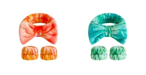 Macro detail of plush tie-dye coral and teal bow headbands with matching wristbands set