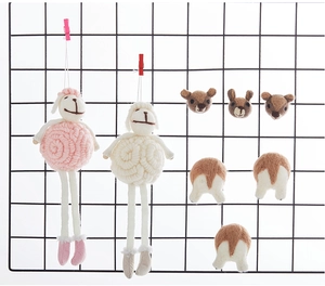 Handmade wool felt animal charms including sheep and corgi butt DIY ornaments on grid