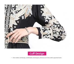 Detail of bohemian paisley print on black satin dress with buttoned cuff design