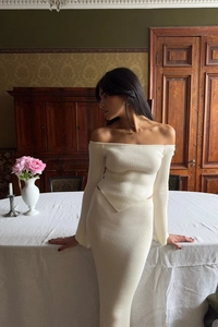 Detail of white off-shoulder knit top and maxi skirt set with ribbed texture finish