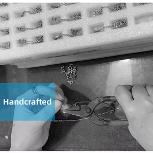 Macro shot of handmade production process for silver flower and star bullet necklaces