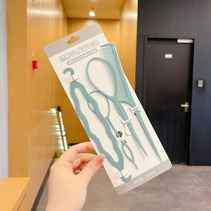 Macro shot of 4-piece hair styling set including loop tools and comb in mint green