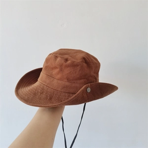 Close-up of caramel outdoor sun hat with black windproof rope and metal buckle