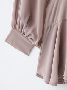 Detail of the elegant pleated waist and wide cuff on this dusty pink chiffon mini dress