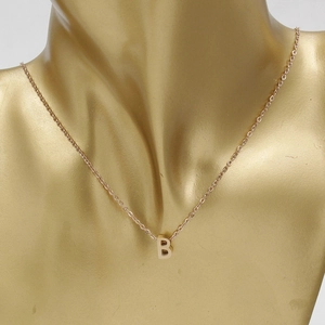Polished rose gold necklace with letter B pendant shown on a professional golden bust