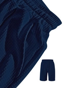 Detail of navy blue waffle knit texture and elastic drawstring waistband on casual shorts
