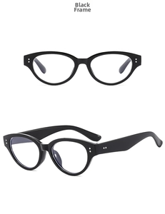 Detail of black cat-eye glasses with clear lenses and metallic stud accents on the frame