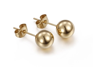 Macro detail of polished gold ball stud earrings with butterfly backs on white background