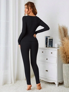 Detail showing the texture of black ribbed knit long sleeve top and pants lounge set