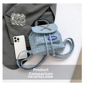 Close-up of sequined denim mini backpack with distressed details and silver chain trim