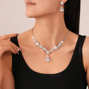Close-up of model wearing silver teardrop zircon necklace and earrings set