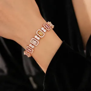 Luxury rose gold bracelet with emerald-cut crystals shown on a model wrist for women