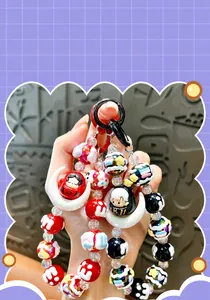 Detailed macro shot of a cute colorful hand-painted moon bead phone charm with acrylic beads