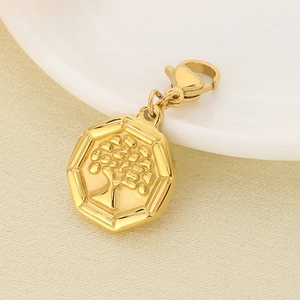 Macro shot of gold octagonal Tree of Life pendant with lobster clasp on white ceramic