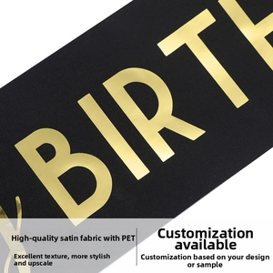 Close-up of premium black satin party sash with gold foil BIRTH lettering detail