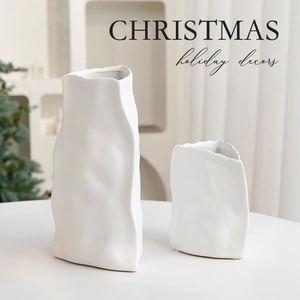 Set of two white ceramic vases with paper bag texture for Christmas table decor