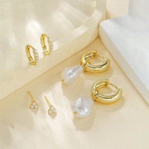 Irregular chunky C-shape gold plated earrings set with baroque pearls and zircon