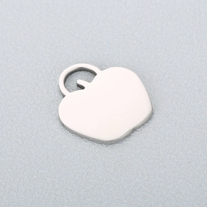 Detailed close-up of a heart-shaped stainless steel apple pendant with a polished gold finish