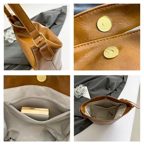 Detail view of brown textured tote bag showing magnetic clasp and gray inner lining