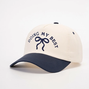 Detailed embroidery of Doing My Best text and blue bow on contrast baseball cap
