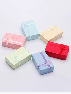 Multi-colored jewelry gift boxes with elegant ribbon bows in a circular arrangement