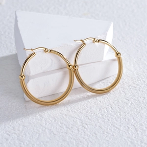 Three-layer gold titanium steel hoop earrings with textured spring coil and smooth finish