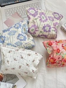 Set of four floral canvas cosmetic bags with vintage flower prints and zipper closure