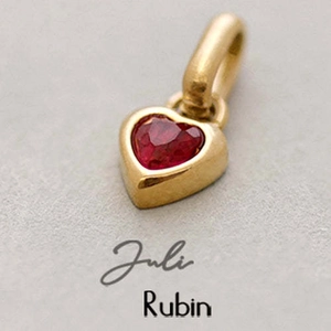 Detailed view of heart-shaped gold pendant featuring a vibrant July ruby birthstone