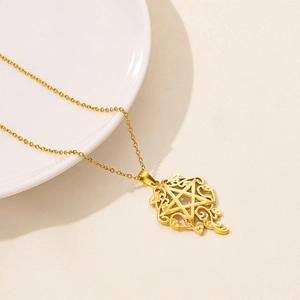 Detail of a gold stainless steel necklace with a hollow star pendant on white ceramic