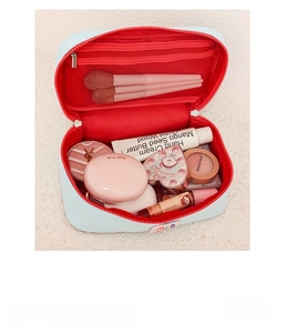 Detail view of the multi-compartment travel makeup bag with mesh pocket and brush slots