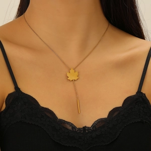 Detail of 18k gold plated maple leaf pendant necklace with tassel on a female model