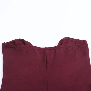 Detail view of burgundy ruched bodycon dress showing high-quality stitching and fabric texture