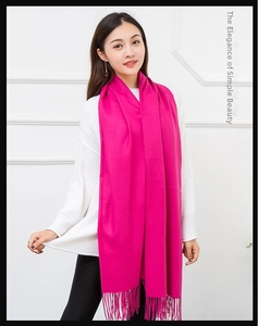 Detail view of rose red cashmere feel scarf with long tassels showing premium texture