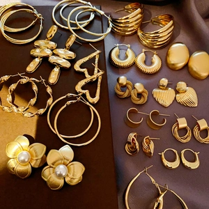 Detailed collection of gold geometric earrings including hoops and heart charms