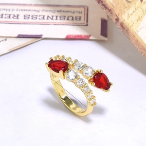 Macro detail of gold plated ring with teardrop red zircon and 17mm inner diameter