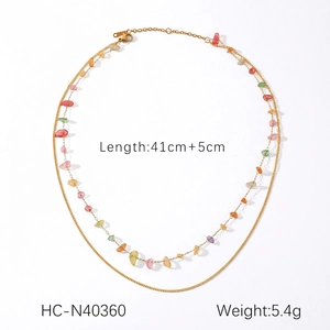 Detail of double-layer gold chain necklace with colorful natural stone fragments