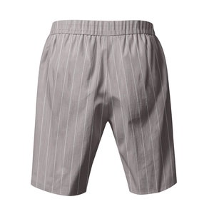 Detail of grey striped linen beach shorts showing elastic waistband and fabric texture